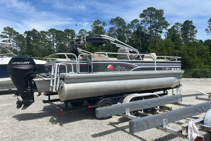 Slide: The Image of 2015 Sun Tracker Party Barge 22 Tritoon with Mercury outboard motor on trailer. - 5