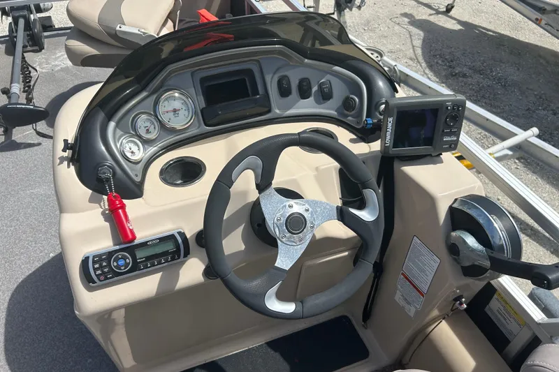 Slide: The Image of 2015 Sun Tracker Party Barge 22 Tritoon dashboard with steering wheel and control panel. - 6