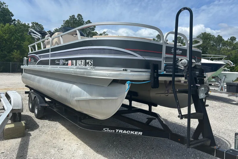 Slide: The Image of 2015 Sun Tracker Party Barge 22 Tritoon on trailer, parked outdoors. - 9