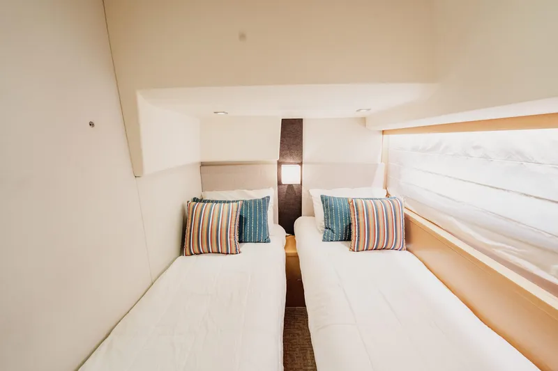 Slide: The Image of Luxurious twin cabin interior of 2013 Prestige 500S yacht with striped pillows. - 52