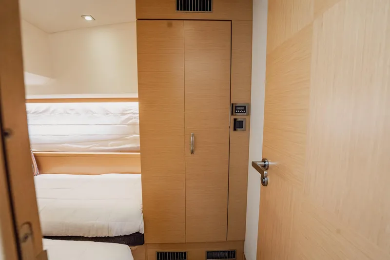 Slide: The Image of Interior of 2013 Prestige 500S yacht with wooden cabinetry and cozy bedding. - 54