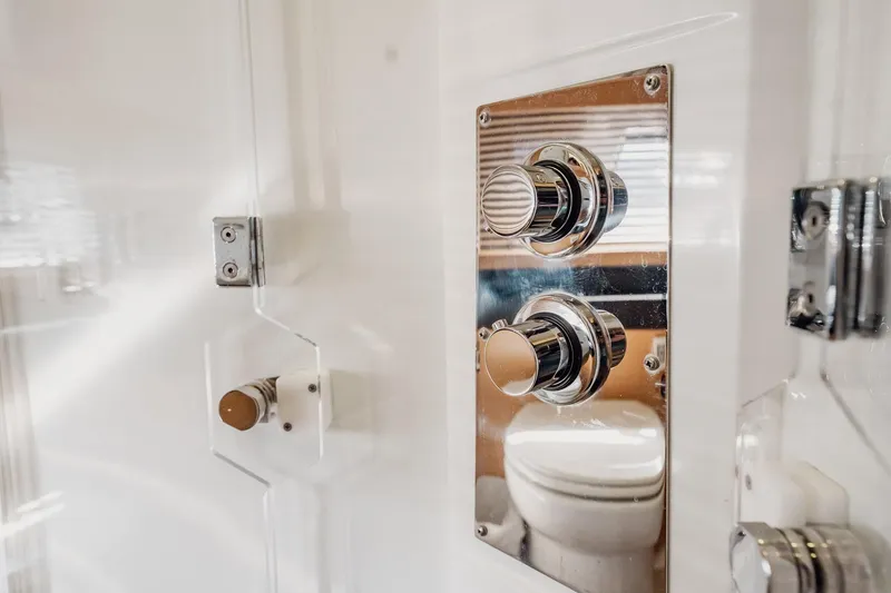 Slide: The Image of Control panel in 2013 Prestige 500S yacht bathroom, featuring chrome knobs and sleek design. - 57