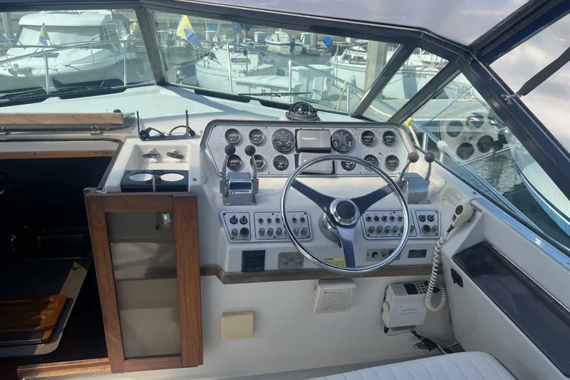 Slide: The Image of Cockpit of a 1985 Tiara 25 boat with steering wheel and control panel. - 9