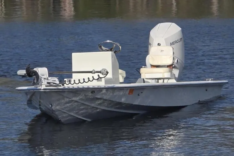 Slide: The Image of 1988 Lake & Bay Boca Grande 20 boat on calm water with Mercury engine. - 1