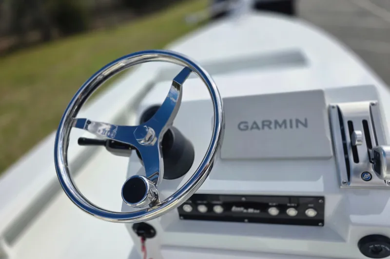 Slide: The Image of Steering wheel and Garmin system on 1988 Lake & Bay Boca Grande 20 boat. - 11