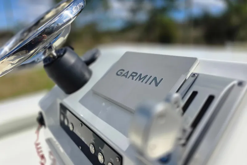 Slide: The Image of Close-up of Garmin device on 1988 Lake & Bay Boca Grande 20 boat dashboard. - 12