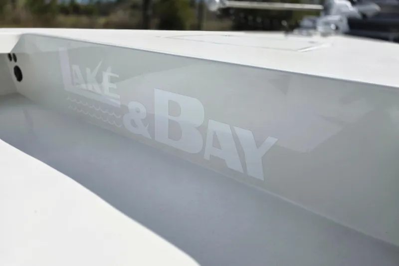 Slide: The Image of 1988 Lake & Bay Boca Grande 20 boat with logo detail on white surface. - 16