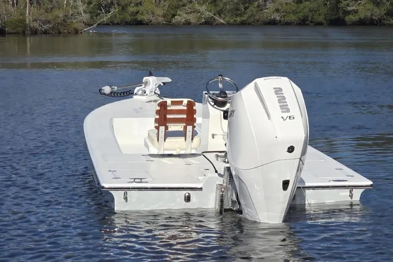 Slide: The Image of 1988 Lake & Bay Boca Grande 20 boat with Mercury V6 engine on calm water. - 2