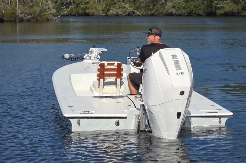 Slide: The Image of Man steering 1988 Lake & Bay Boca Grande 20 boat on calm water. - 26