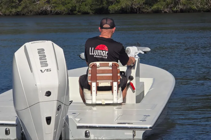 Slide: The Image of Man steering 1988 Lake & Bay Boca Grande 20 boat with Mercury 225 V6 engine. - 27