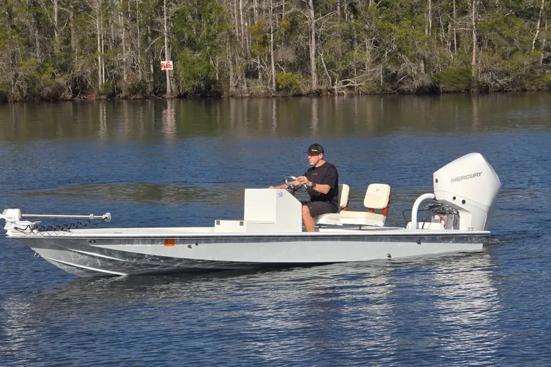 Slide: The Image of Man operating 1988 Lake & Bay Boca Grande 20 boat on calm water. - 30