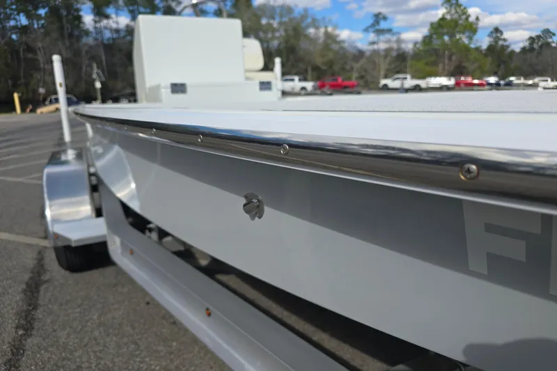 Slide: The Image of 1988 Lake & Bay Boca Grande 20 boat on trailer, parked in lot with trees in background. - 31
