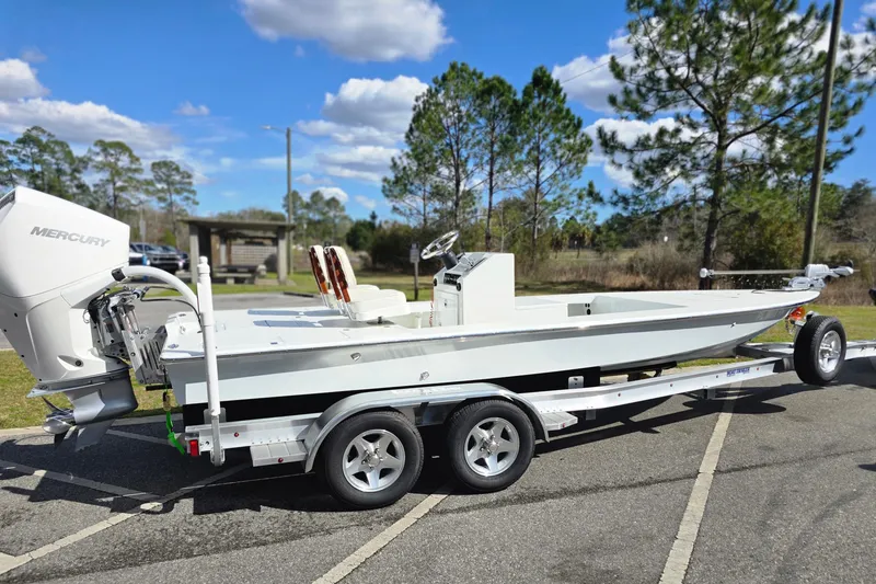 Slide: The Image of 1988 Lake & Bay Boca Grande 20 boat on trailer, parked outdoors under blue sky. - 9