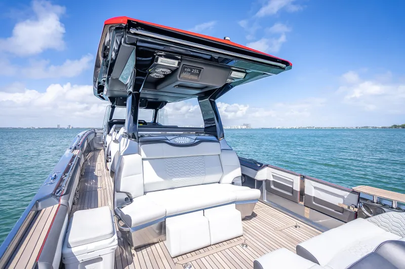 Slide: The Image of 2022 Nor-Tech 500 Sport Center Console boat on open water, featuring luxurious seating. - 12