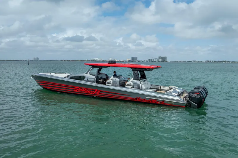 Slide: The Image of 2022 Nor-Tech 500 Sport Center Console boat on calm water under cloudy sky. - 18