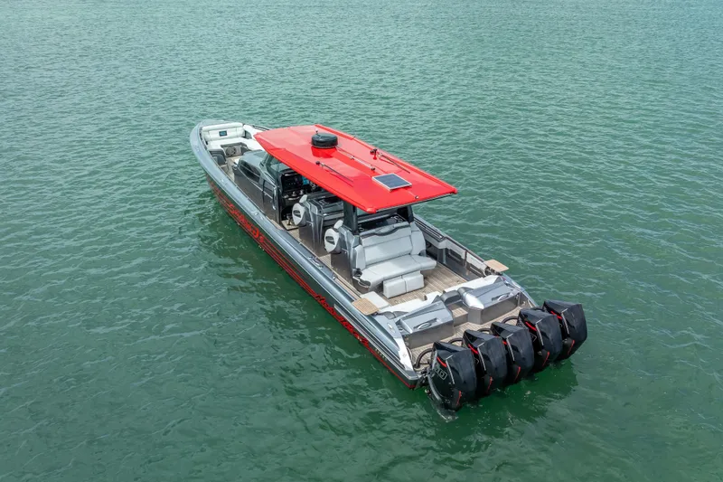 Slide: The Image of 2022 Nor-Tech 500 Sport Center Console boat with red roof on water. - 19