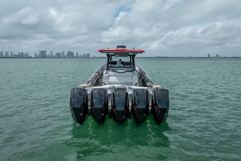 Slide: The Image of 2022 Nor-Tech 500 Sport Center Console boat with five engines on open water. - 21