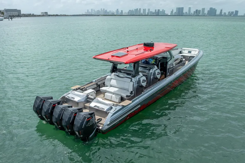 Slide: The Image of 2022 Nor-Tech 500 Sport Center Console boat with red roof on calm water. - 22