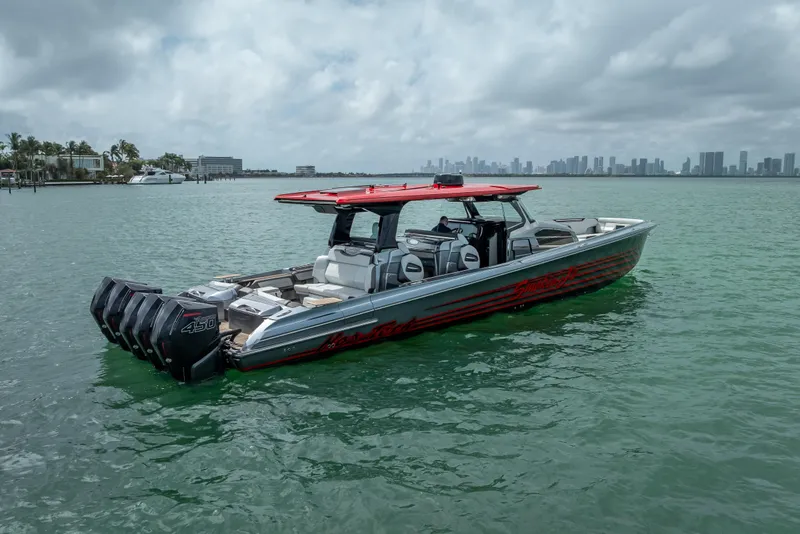 Slide: The Image of 2022 Nor-Tech 500 Sport Center Console boat on calm water with city skyline. - 23