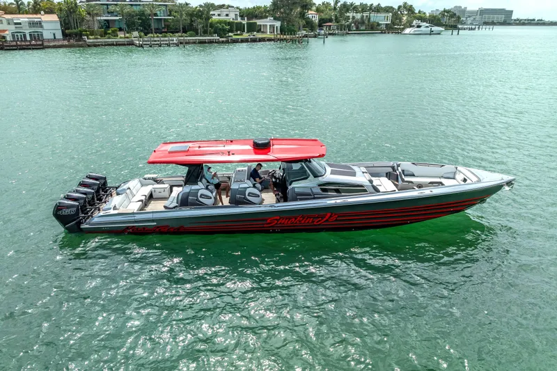 Slide: The Image of 2022 Nor-Tech 500 Sport Center Console boat on water, featuring red accents and multiple engines. - 24