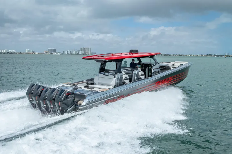 Slide: The Image of 2022 Nor-Tech 500 Sport Center Console cruising on open water with city skyline backdrop. - 27