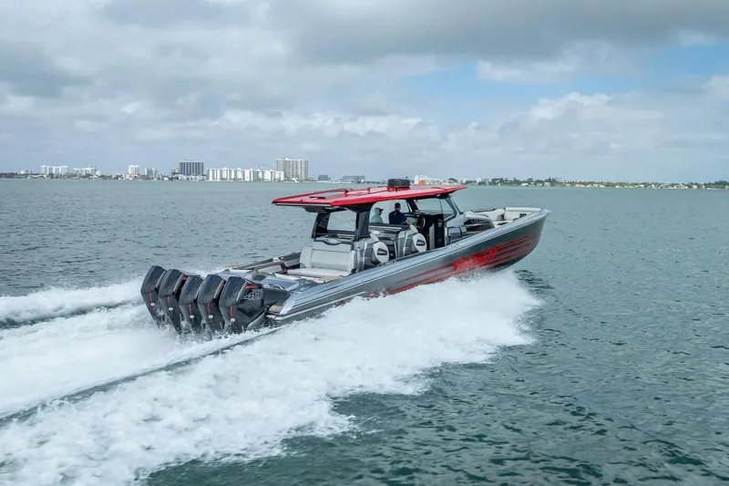 Slide: The Image of 2022 Nor-Tech 500 Sport Center Console cruising on open water with city skyline backdrop. - 29