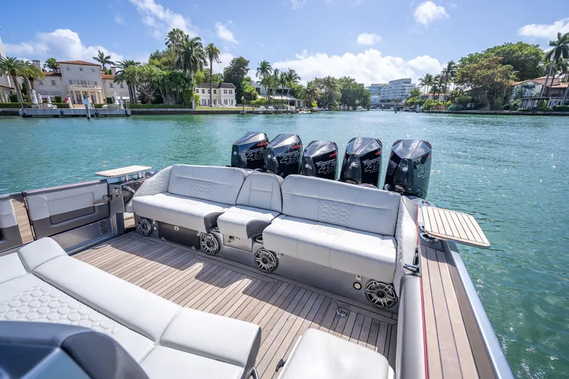 Slide: The Image of 2022 Nor-Tech 500 Sport Center Console boat with luxurious seating and powerful engines. - 3