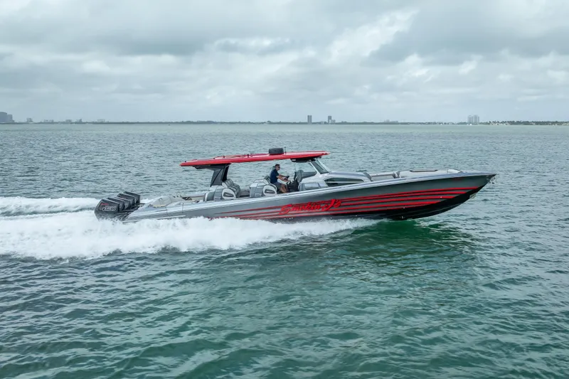 Slide: The Image of 2022 Nor-Tech 500 Sport Center Console cruising on open water, showcasing sleek design. - 31