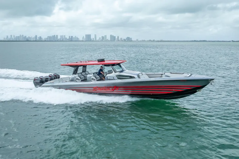 Slide: The Image of 2022 Nor-Tech 500 Sport Center Console cruising on open water with city skyline backdrop. - 33