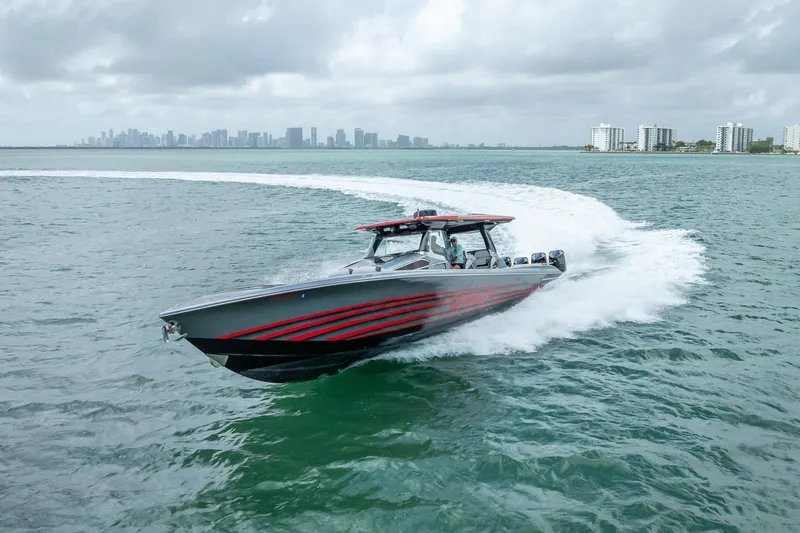 Slide: The Image of 2022 Nor-Tech 500 Sport Center Console cruising on open water with city skyline backdrop. - 35