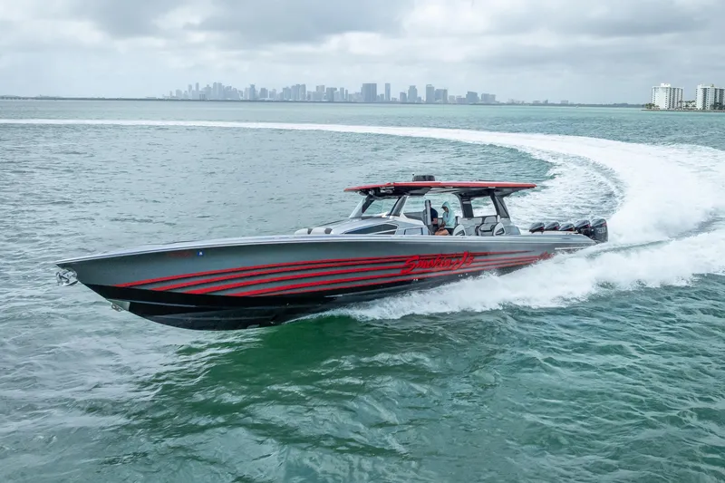 Slide: The Image of 2022 Nor-Tech 500 Sport Center Console cruising on open water with city skyline backdrop. - 36