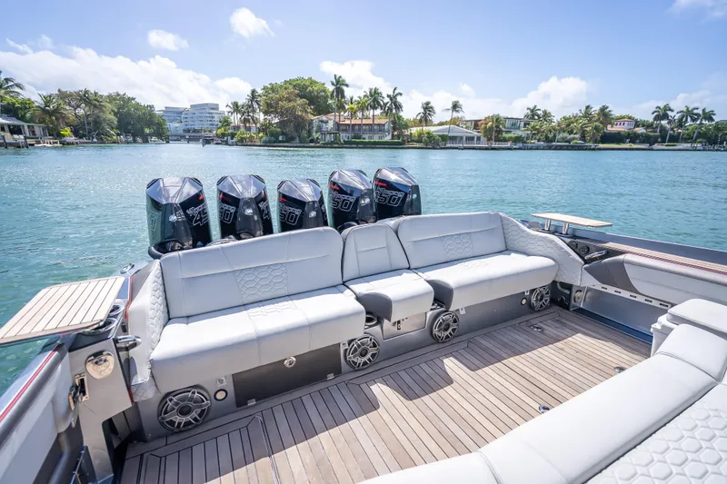 Slide: The Image of 2022 Nor-Tech 500 Sport Center Console boat with luxurious seating and powerful engines. - 4