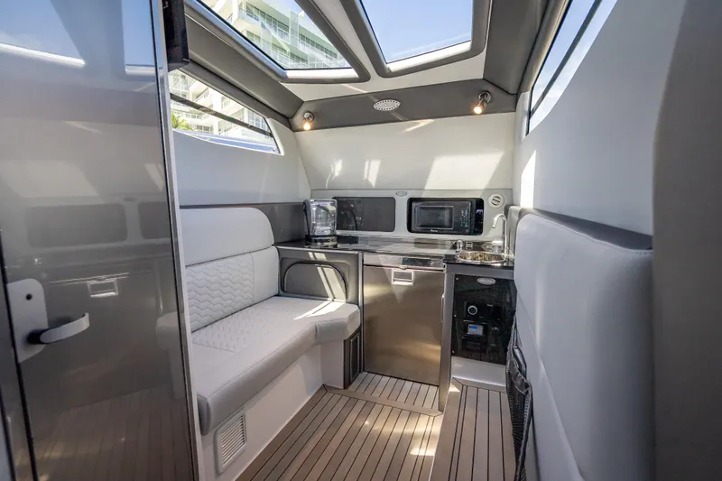 Slide: The Image of Luxurious interior of 2022 Nor-Tech 500 Sport Center Console with modern kitchenette and seating. - 41