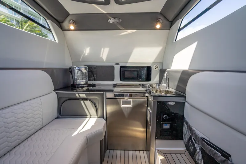 Slide: The Image of Luxurious interior of 2022 Nor-Tech 500 Sport Center Console boat with kitchenette and seating. - 43