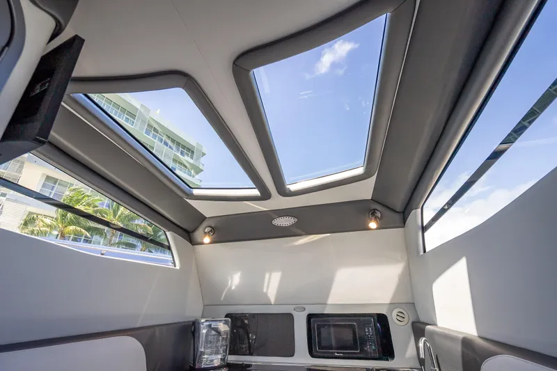Slide: The Image of Interior view of 2022 Nor-Tech 500 Sport Center Console with skylights and modern amenities. - 44