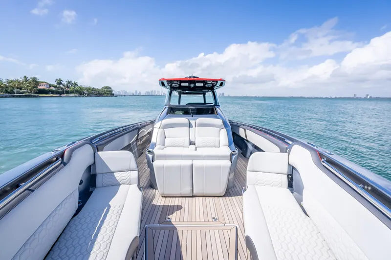 Slide: The Image of 2022 Nor-Tech 500 Sport Center Console boat on calm water, featuring luxurious seating. - 49