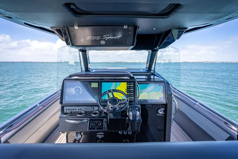 Slide: The Image of 2022 Nor-Tech 500 Sport Center Console helm with advanced navigation displays on open water. - 5