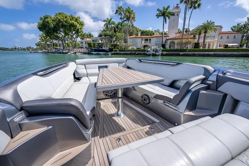 Slide: The Image of Luxurious 2022 Nor-Tech 500 Sport Center Console boat interior with elegant seating and table. - 55