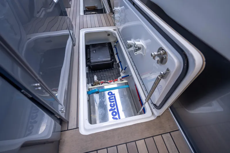 Slide: The Image of Open storage compartment on 2022 Nor-Tech 500 Sport Center Console boat. - 59