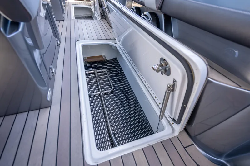 Slide: The Image of Open storage compartment on 2022 Nor-Tech 500 Sport Center Console boat deck. - 60