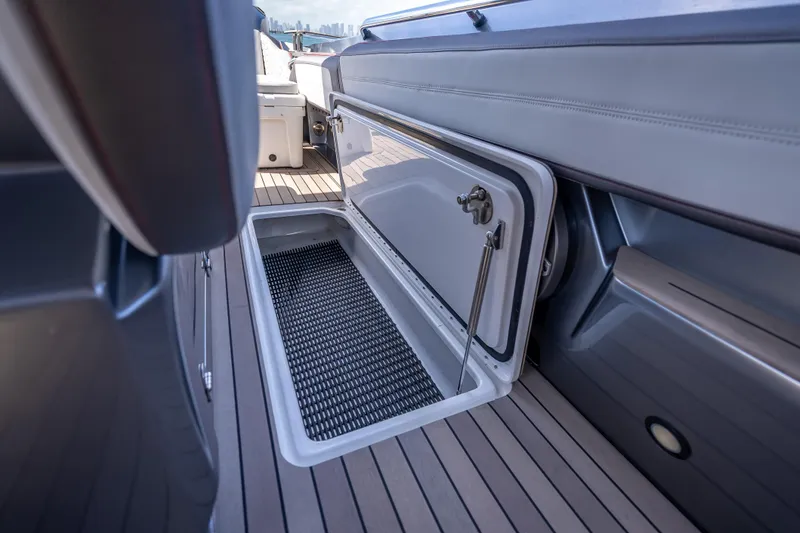 Slide: The Image of Open storage compartment on 2022 Nor-Tech 500 Sport Center Console boat deck. - 63