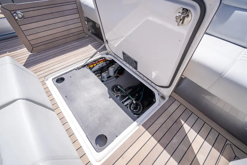 Slide: The Image of Open storage compartment on 2022 Nor-Tech 500 Sport Center Console boat deck. - 64