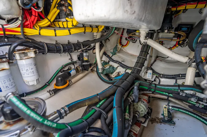 Slide: The Image of Engine compartment of 2022 Nor-Tech 500 Sport Center Console with complex wiring and hoses. - 66