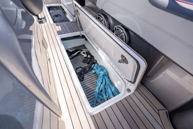 Slide: The Image of 2022 Nor-Tech 500 Sport Center Console storage compartment with ropes on deck. - 68