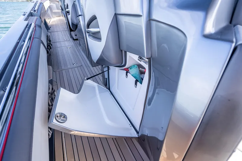 Slide: The Image of 2022 Nor-Tech 500 Sport Center Console interior with open storage compartment. - 70