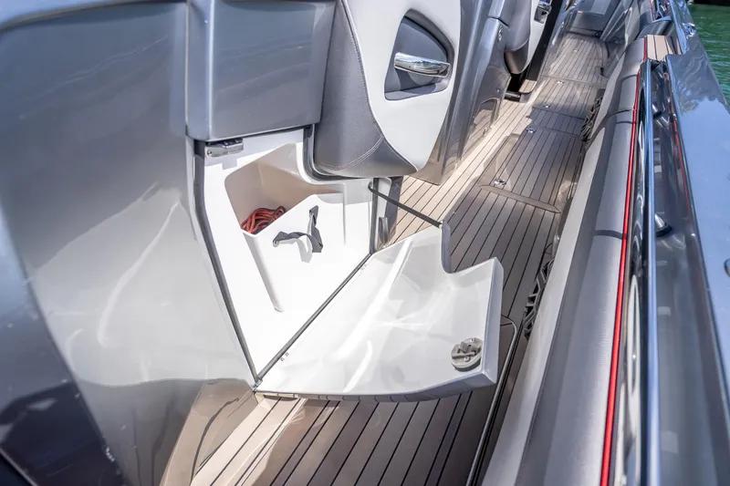 Slide: The Image of 2022 Nor-Tech 500 Sport Center Console interior storage compartment with open hatch. - 74