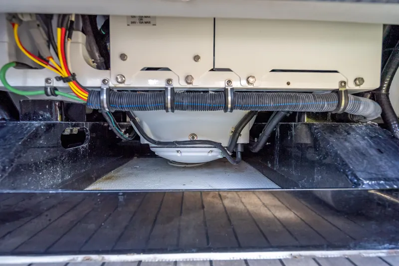 Slide: The Image of Engine compartment of 2022 Nor-Tech 500 Sport Center Console boat, showcasing wiring and components. - 75