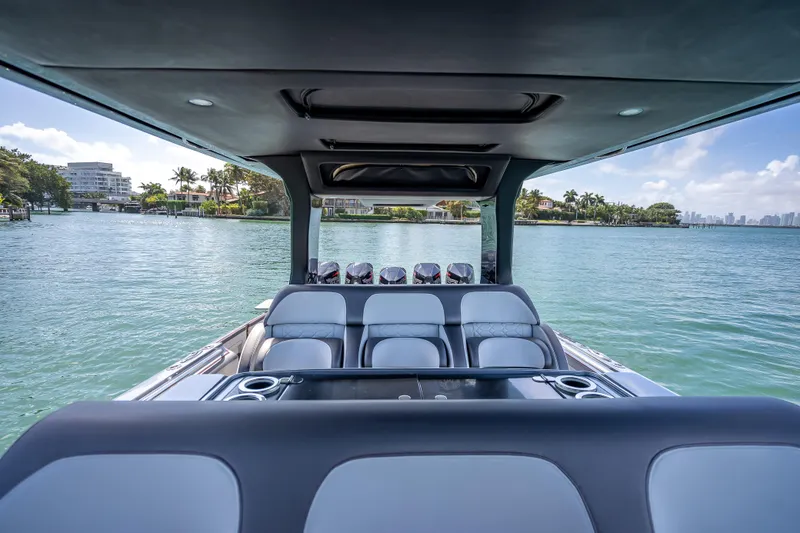 Slide: The Image of 2022 Nor-Tech 500 Sport Center Console boat on serene water with luxurious seating. - 78