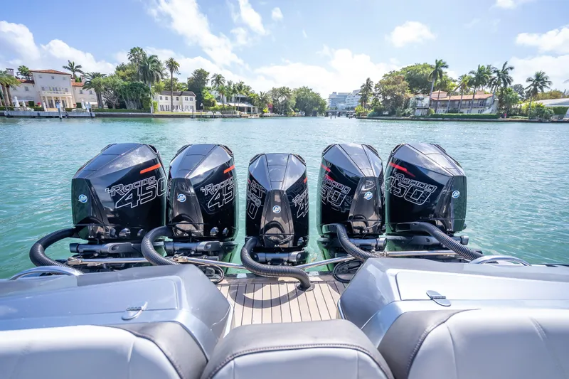 Slide: The Image of 2022 Nor-Tech 500 Sport Center Console with five powerful outboard engines on a scenic waterway. - 8