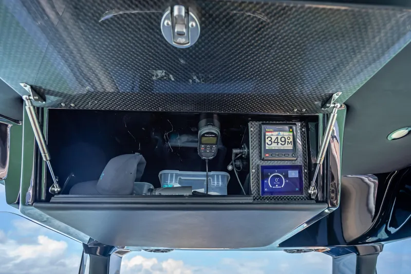 Slide: The Image of 2022 Nor-Tech 500 Sport Center Console dashboard with navigation instruments and storage compartment. - 83